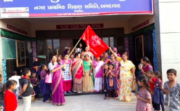Teacher hosting a flag signifying a bad air day as part of the Schools Flag Program implemented as part of the AIR Plan in Ahmedabad. Source: AMC